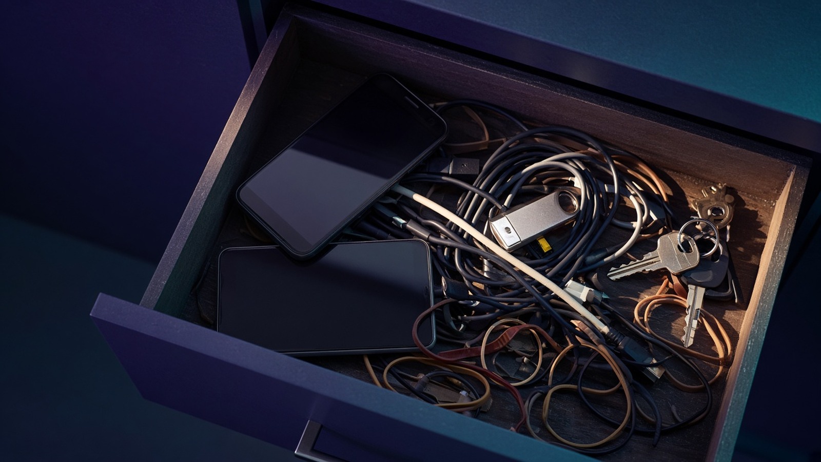 Open drawer filled with old phones